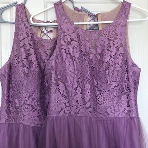 Two lavender bridesmaid dresses.